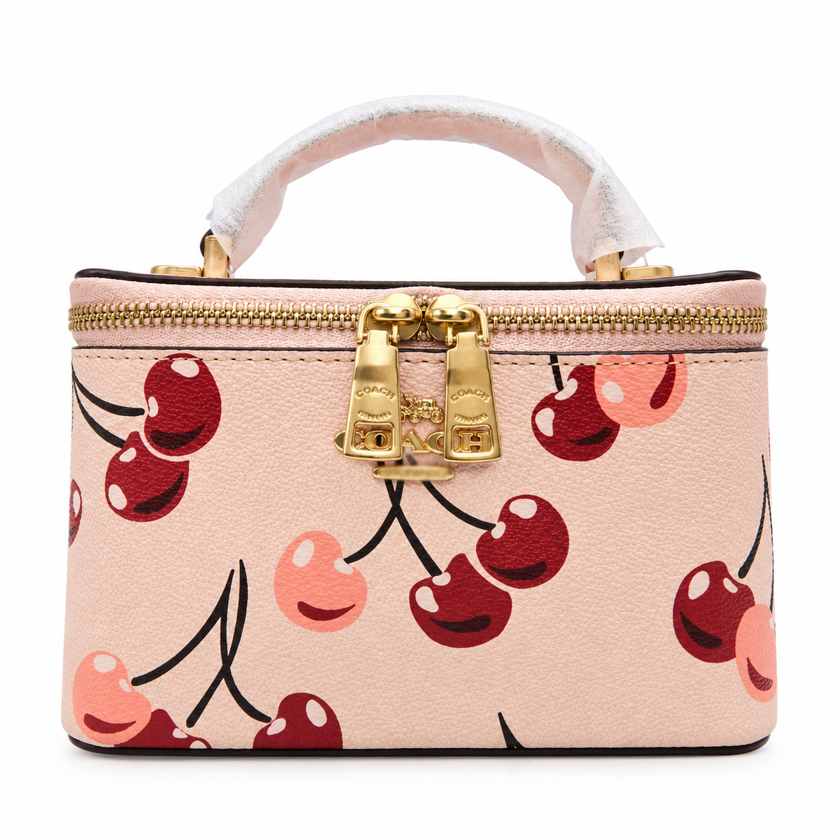 A structured top-handle handbag in light pink pebbled leather with a cherry print, featuring gold-tone hardware and a white protective wrap on the handle, shown against a plain white background.